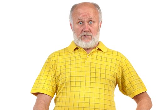 amazed and astonished senior bald man in yellow shirt