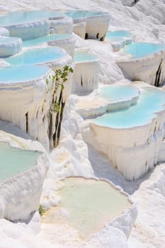 Blue cyan water travertine pools at ancient Hierapolis, now Pamukkale, Turkey