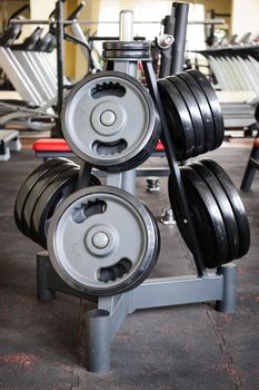 Gym interior with barbell plates holder rack