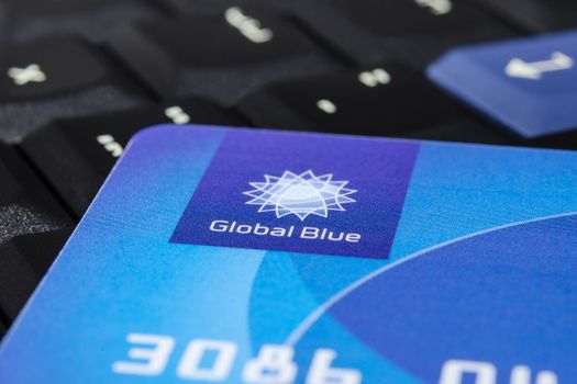 MUNICH, GERMANY - FEBRUAR 20, 2014: Plastic "Global Blue" card on laptop ThinkPad keyboard. Easy for tax free shopping.