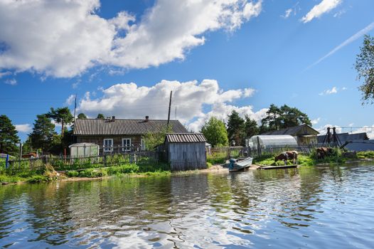 Traditional wooden house in rural area at the north of Russia