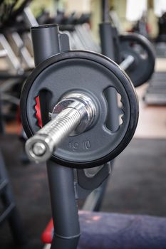 Barbell ready to workout, indooors, shallow DOF