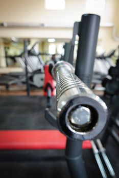 Empty barbell bar waiting to workout, shallow DOF
