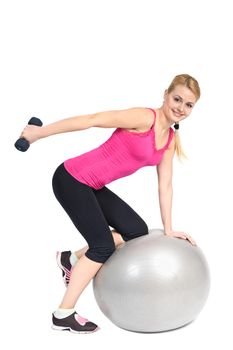 Young woman doing Standing Bent-Over Dumbbell Triceps Extension on Fitnes Ball, phase 2 of 2.