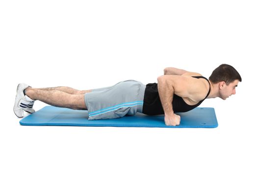 young man performing push-ups exercise on fists, on white background