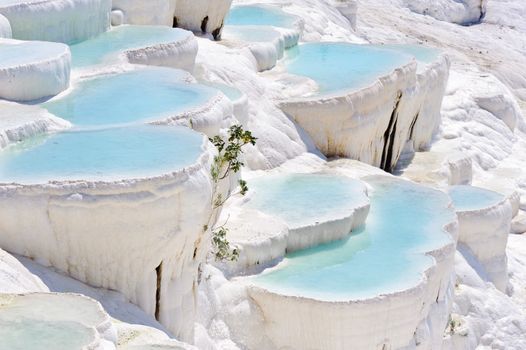 Blue cyan water travertine pools at ancient Hierapolis, now Pamukkale, Turkey