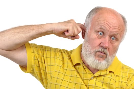goofy bald senior man picking his ear with index finger