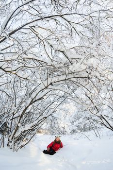 beautiful young girl in funny hat playing in fresh snow
