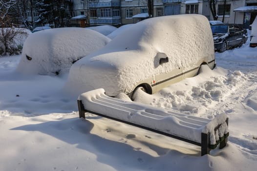 Cars covered with snow in residental area