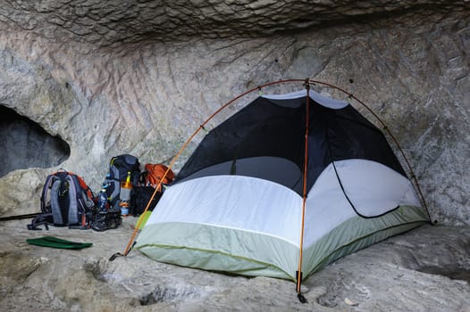 Camp, backpacks and one tent in the cave