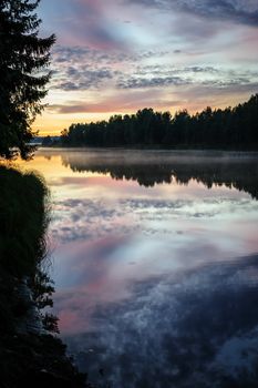 Dramatic sunset over the river in Karelia, the north of Russia