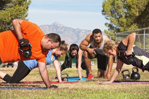 Male instructor training mature adults in boot camp fitness