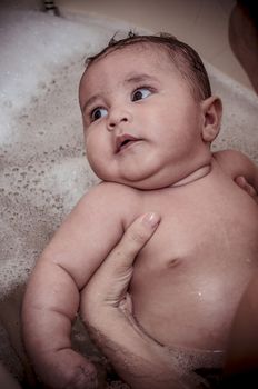 bath, new born baby curled up sleeping on a blanket, multiple expressions