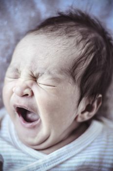 Yawn, new born baby curled up sleeping on a blanket, multiple expressions