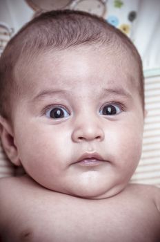 new born baby curled up sleeping on a blanket, multiple expressions