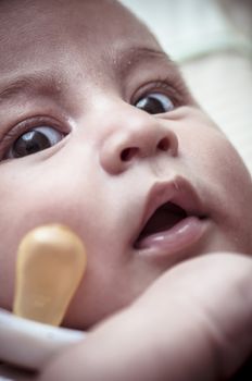 Pacifier, new born baby curled up sleeping on a blanket, multiple expressions