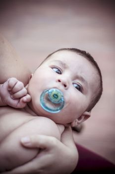 Pacifier, new born baby curled up sleeping on a blanket, multiple expressions