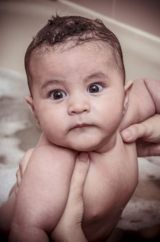 bath, new born baby curled up sleeping on a blanket, multiple expressions