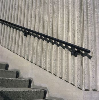 Concrete steps and iron railings with groove concrete wall