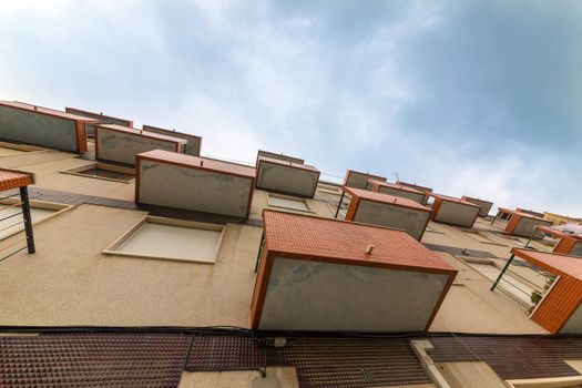 Balconies Old Apartments on cloud sky background, shoot up