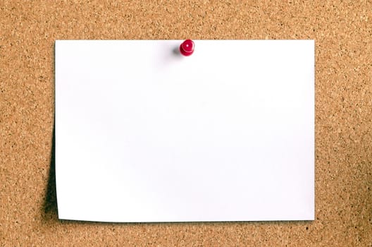 closeup of blank note paper on cork board 