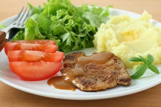 fried pork with mashed potato and salad