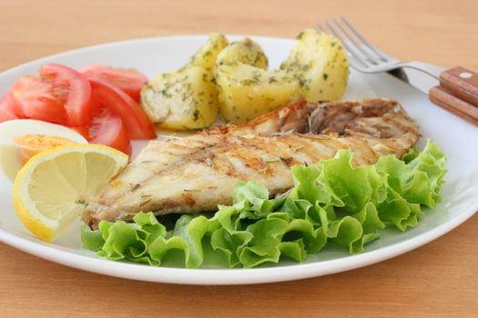 grilled fish with potato and salad