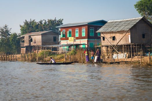 NYAUNG SHWE, INLE LAKE, MYANMAR (Burma) - 07 JAN 2014: Traditional stilts wooden and bamboo house of Intha people in water on Inle lake, Myanmar (Burma) 