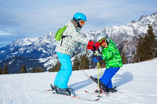 Ski, winter, snow, skiers, sun and fun - kids having fun winter vacations.