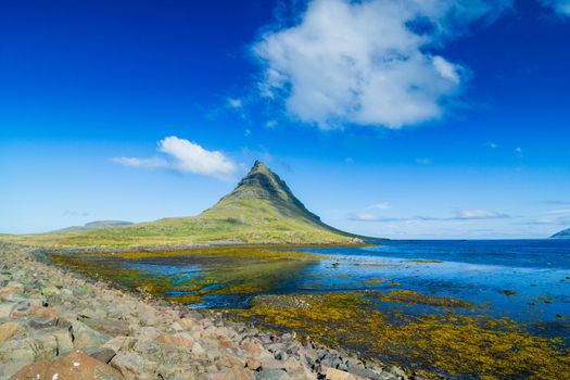 Western Icelandic Kirkjufell mountain landscape under a blue summer sky. Snaefellsnes peninsula