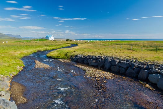 Summer Iceland Landscape with River, Green Fields and Bright Blue Sky