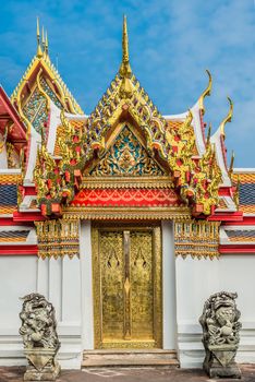 golden door and dragon statues at Wat Pho temple bangkok thailand