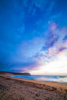 Sunset at the white beach at Iceland ocean coast. Vertical view