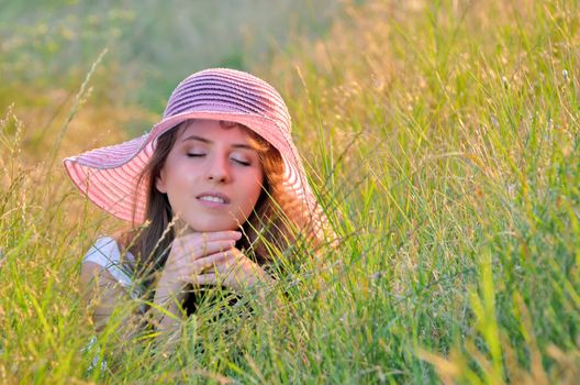 girl lies among the wild flowers in summer time