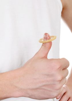 Man holding the Condom on the Thumb and shows OK Gesture closeup