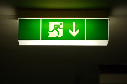 Emergency exit sign glowing in the dark