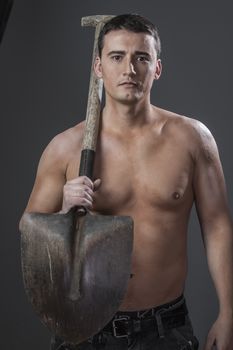 Occupation, Male worker holding a shovel, sexy builder