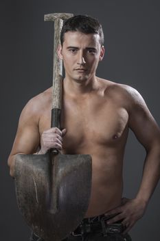 Labour, Male worker holding a shovel, sexy builder