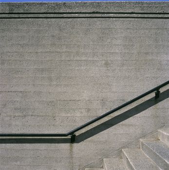 Concrete steps and iron railings with groove concrete wall