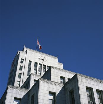 Large city hall building with canadian flag