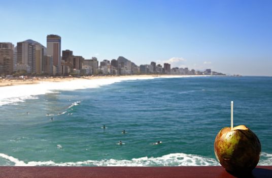 agua de coco national drink in font of beautiful ipanema Leblon beach in rio de janeiro brazil