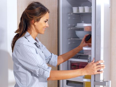 Young woman in front of the fridge