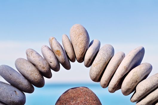 Stone in the middle of arc of pebbles