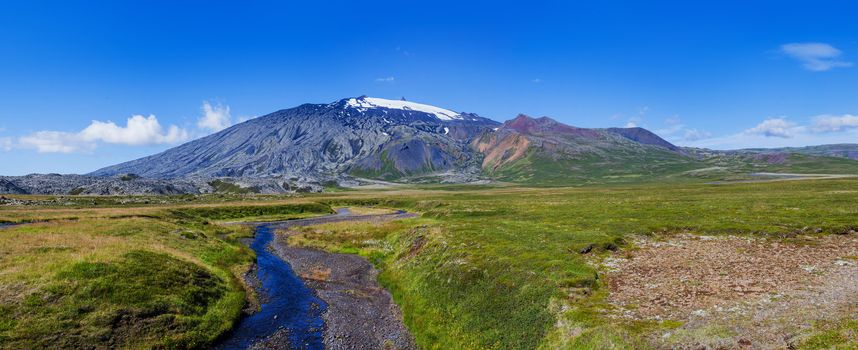 Summer Iceland Landscape with River, Green Fields and Bright Blue Sky. Panorama