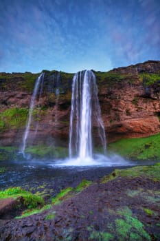 Seljalandfoss waterfall at sunset, Iceland. Horizontal shot.