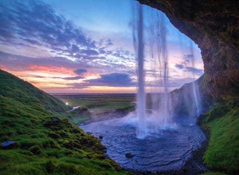 Seljalandfoss waterfall at sunset, Iceland. Horizontal shot.