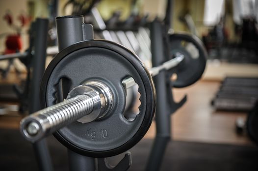 Barbell ready to workout, indooors, shallow DOF