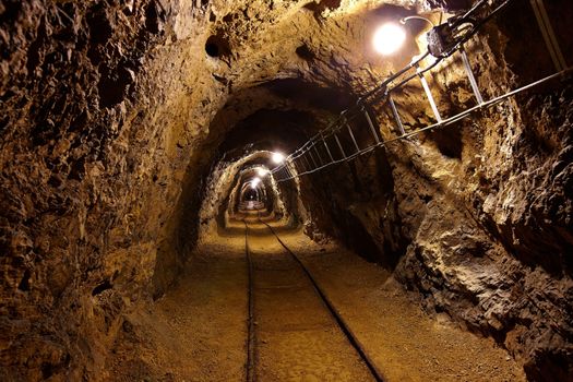 Mining tunnel with lights and rails