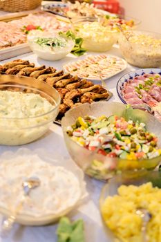 Catering buffet with different salads and chicken meat