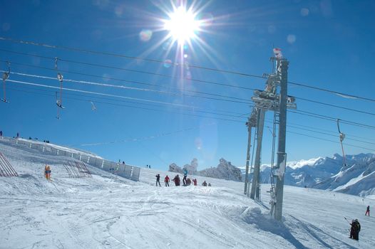 Drag lift and skiers on Hintertux glacier nearby Zillertal valley in Austria